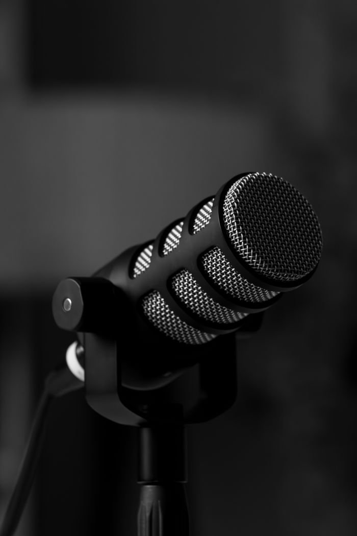 Black and white close-up of a microphone, perfect for podcasting and audio recording visuals.